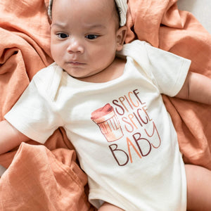 Spice Spice Baby graphic bodysuit for infants, short sleeve, stylish design, angle view showcasing vibrant colors.