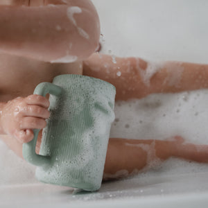 Colorful bath rinse cup for babies, designed for easy rinsing at bath time. Angle view showcasing its ergonomic shape.