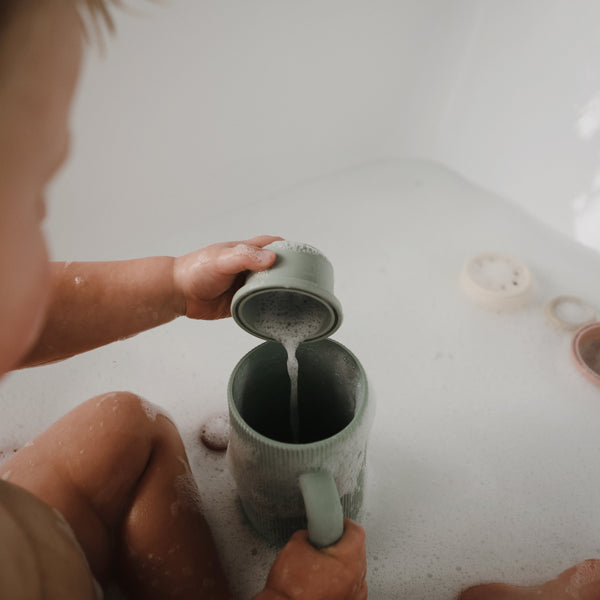 Colorful bath rinse cup for babies, angled view showcasing its ergonomic design and easy grip for bath time fun.