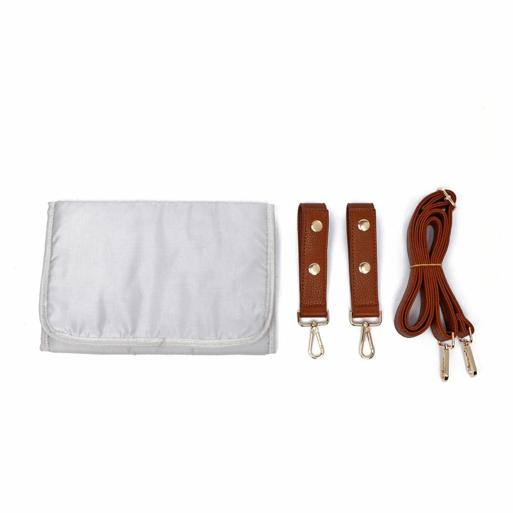 Stylish caramel Signature Diaper Bag for parents, featuring spacious compartments and a chic design.