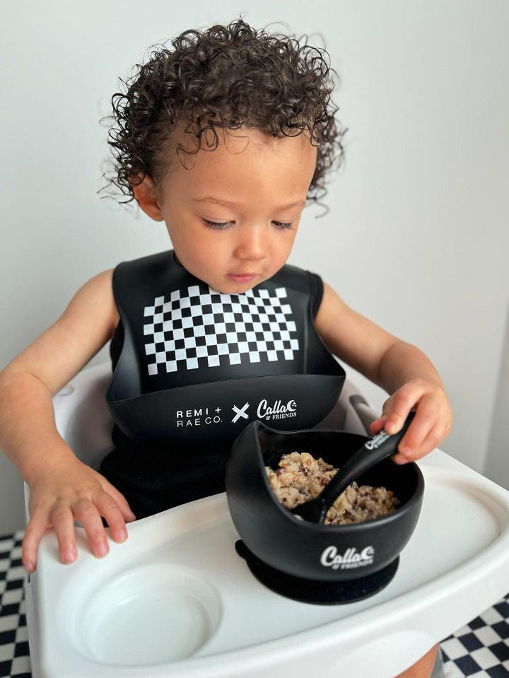 RRCO x C&F Checked Out Catch All Silicone Bib in stylish checkered design for easy feeding and mess-free mealtime.