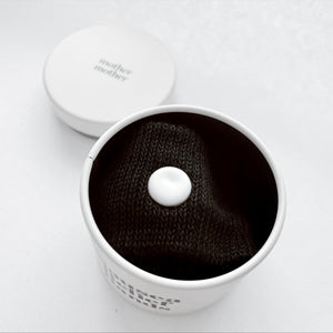 Nausea relief bands for babies, providing comfort and wellness support from an angled view.
