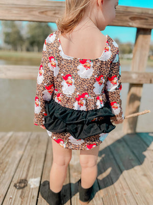 Leopard Santa ruffle romper for babies, festive holiday outfit, stylish and cute design, angle view.