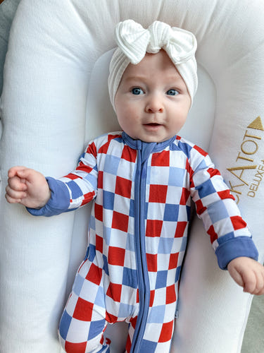 RWB Check Zippy baby bedding for cozy sleep, featuring a stylish red, white, and blue checkered design.