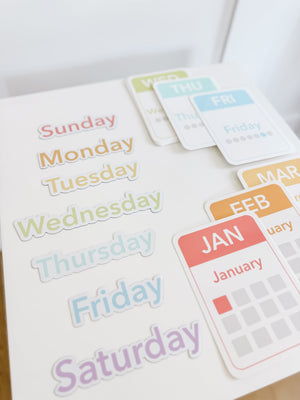 Colorful calendar flashcards and magnets for early learning, featuring days, months, and seasons for sensory play.