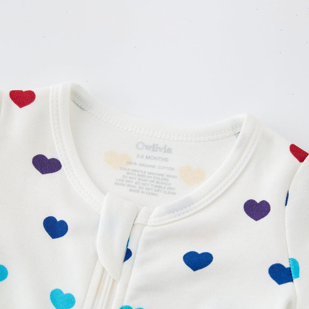 100% Organic Cotton Zip Footed Pajamas in Rainbow Hearts design for babies, soft and cozy sleepwear.