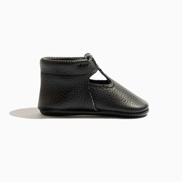 Ebony T-Bar Baby Shoe in angle 3 view, stylish and comfortable for little feet.