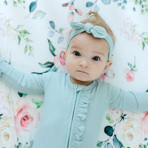 Peach floral fitted crib sheet at angle 7, perfect for adding a touch of charm to your baby's nursery decor.