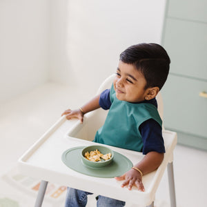 Solid Pine Minimalist Bapron for babies, angle view showcasing its stylish and functional design.