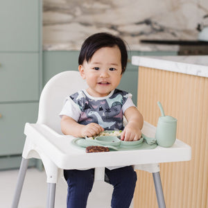 Dinosaur Drawing Bapron for babies, angled view showcasing fun design and practical use for mealtime messes.