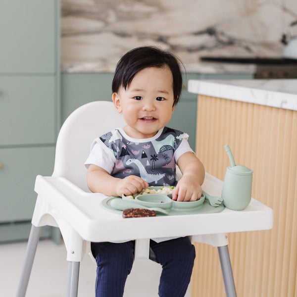 Dinosaur Drawing Bapron for babies, angled view showcasing fun design and practical use for mealtime messes.