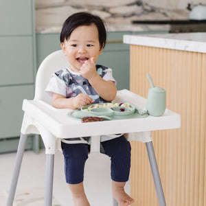 Dinosaur Drawing Bapron for babies, angled view showcasing fun design and practical use for mealtime messes.