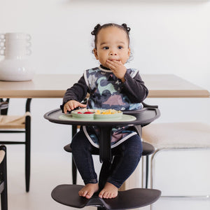 Dinosaur Drawing Bapron for babies, angled view showcasing colorful design and practical features for mess-free mealtime.
