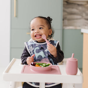 Dinosaur Drawing Bapron for babies, shown from angle 2, perfect for mess-free mealtime and creative play.