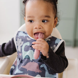 Dinosaur Drawing Bapron for babies, angled view showcasing fun design and practical use for mealtime messes.