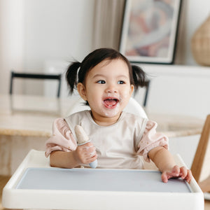 Solid champagne minimalist bapron for babies, showcasing a stylish and practical design from angle 2.