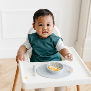 Solid Pine Minimalist Bapron in angle view, perfect for stylish and functional baby feeding.