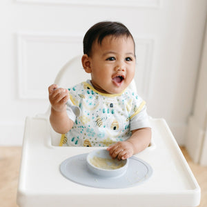 "Busy Bees Bapron in angle 2 view, perfect for mess-free mealtime with babies and toddlers."