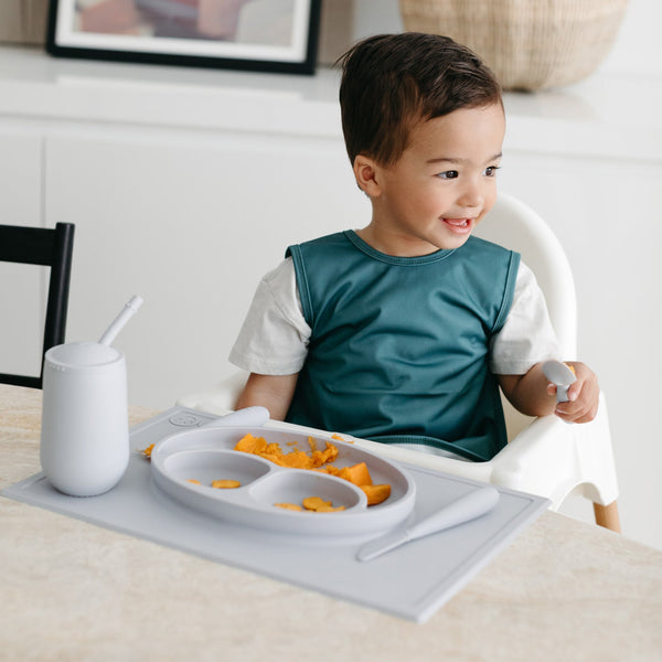 Solid Pine Minimalist Bapron for babies, angled view showcasing its stylish and functional design.