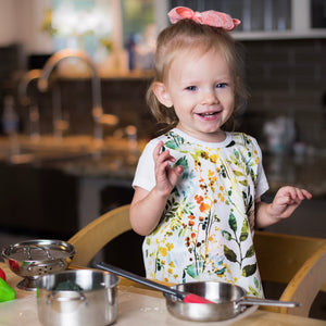 Autumn Leaves Bapron for babies, featuring a vibrant leaf design, angled view showcasing its unique style and functionality.