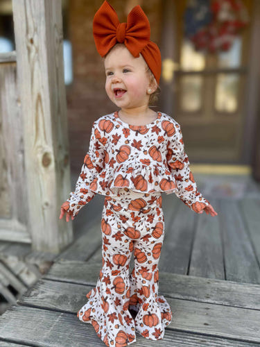High-waisted ruffle bell set with pumpkin and leaves design for babies, perfect for playtime and fall festivities.