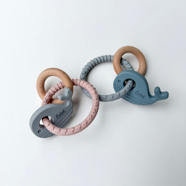 Whale silicone and beechwood teether for babies, perfect for soothing gums and teething relief.