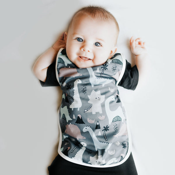 Dinosaur Drawing Bapron for babies, angled view showcasing fun design and practical use for mealtime messes.