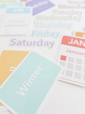 Colorful calendar flashcards and magnets for babies, featuring days, months, and seasons for early learning and sensory play.