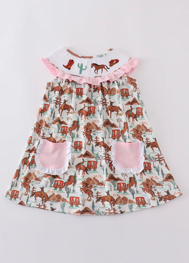 Western smocked girl dress in vibrant colors, perfect for stylish baby outfits.