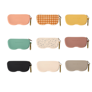 Soft silicone Zip + Go Case in sand color, perfect for baby accessories and seasonal wear. Angle 3 view.