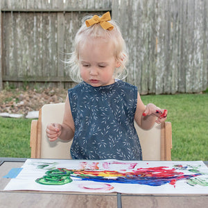 Willow Bapron in angle view, featuring a stylish and functional design for babies during mealtime.