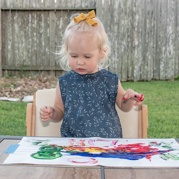 Willow Bapron in angle view, featuring a stylish and functional design for babies during mealtime.