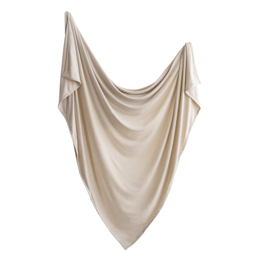 Soft stretchy swaddle for babies, ensuring comfort and security during sleep. Perfect for cozy naps and peaceful nights.