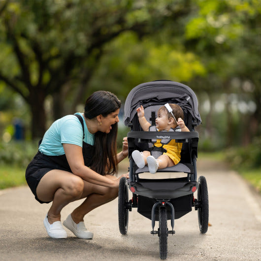 Foldable gray jogging stroller with detachable tray and air-filled rubber tires, perfect for active parents and babies.