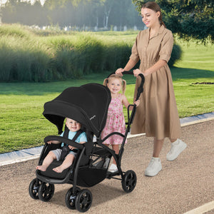Foldable twin tandem stroller in black, featuring adjustable handlebar and sit-and-stand design, viewed from angle 2.