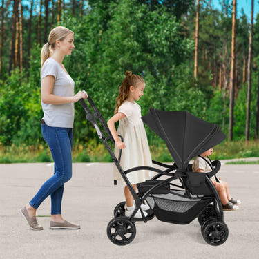Foldable twin tandem stroller in black, featuring adjustable handlebar for sit and stand convenience.