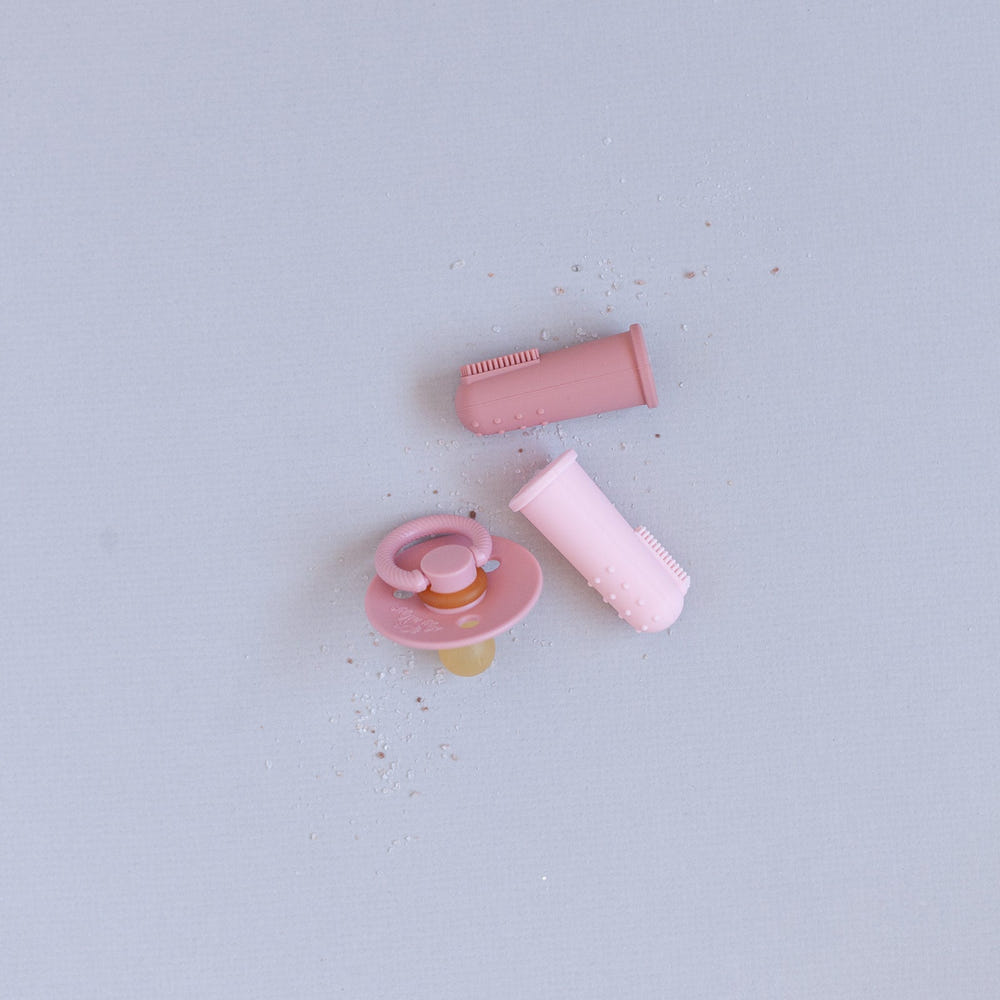 Pink finger toothbrushes for babies, perfect for gentle oral care and teething relief.