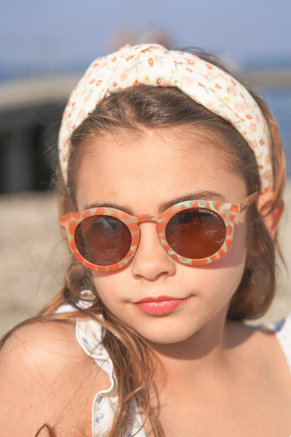 Classic sustainable sunglasses for kids aged 3-8, plant-based, bendable, polarized, angled view.