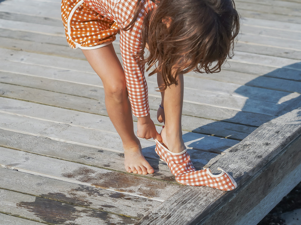 Sienna Gingham baby swim shoes for comfortable and stylish water play. Perfect for little ones at the beach or pool.