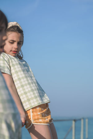Oversized T-Shirt in organic cotton jersey, fern plaid design, angle view showcasing soft, stylish baby clothing.