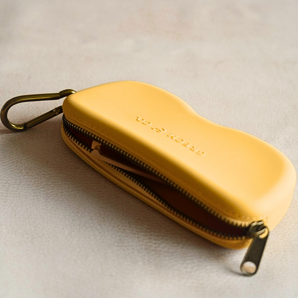 Soft silicone Zip + Go Case in buckwheat color, perfect for baby accessories and seasonal wear.