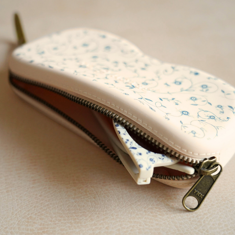 Soft silicone Zip + Go Case in Scandi floral design for babies, perfect accessory for on-the-go convenience.