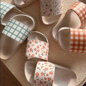Fern plaid slide sandals for babies, showcasing a stylish and comfortable design from an angled view.