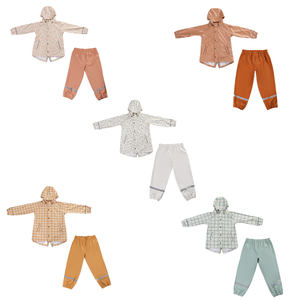 Fern rain pants for babies, showcasing a stylish design from an angled view. Perfect for outdoor adventures!