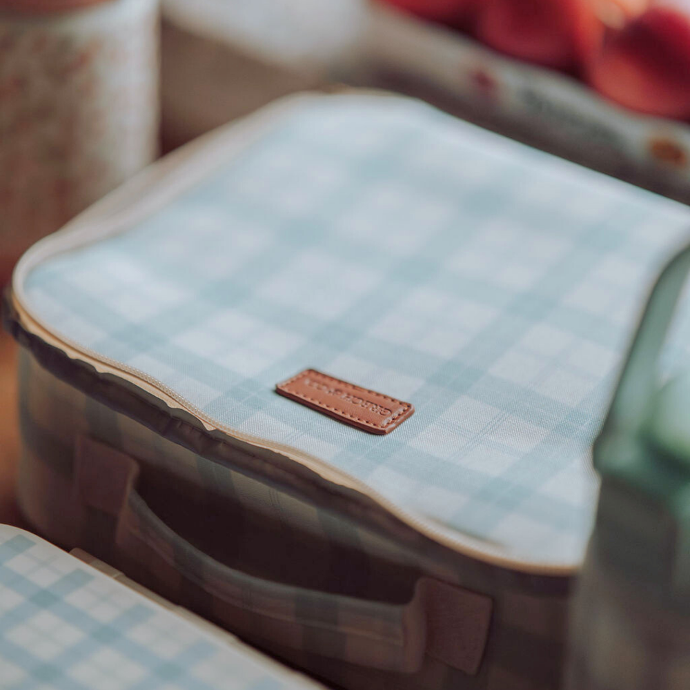 Insulated lunch bag in fern plaid design, perfect for keeping baby food fresh and stylish on the go.