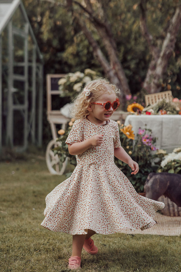 Sweetheart Twirl Dress in Sunset Meadow, organic cotton jersey, angle view, perfect for baby swimwear.
