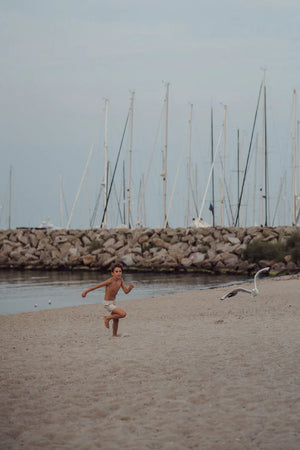 Baby swim trunks in Scandi floral design, UPF protection, made from recycled materials, angle view 14.