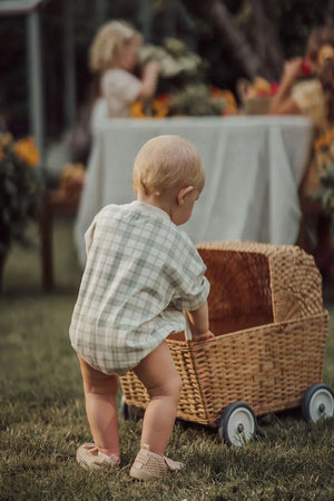 Organic cotton bubble romper in fern plaid, angle view showcasing soft fabric and playful design for babies.