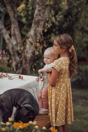 Sweetheart Twirl Dress in Buckwheat Plaid, made from organic cotton jersey, perfect for baby swimwear.