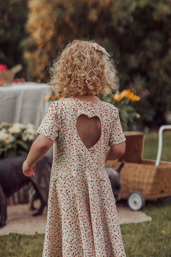 Sweetheart Twirl Dress in Sunset Meadow, organic cotton jersey swimwear for babies, angle view 5.